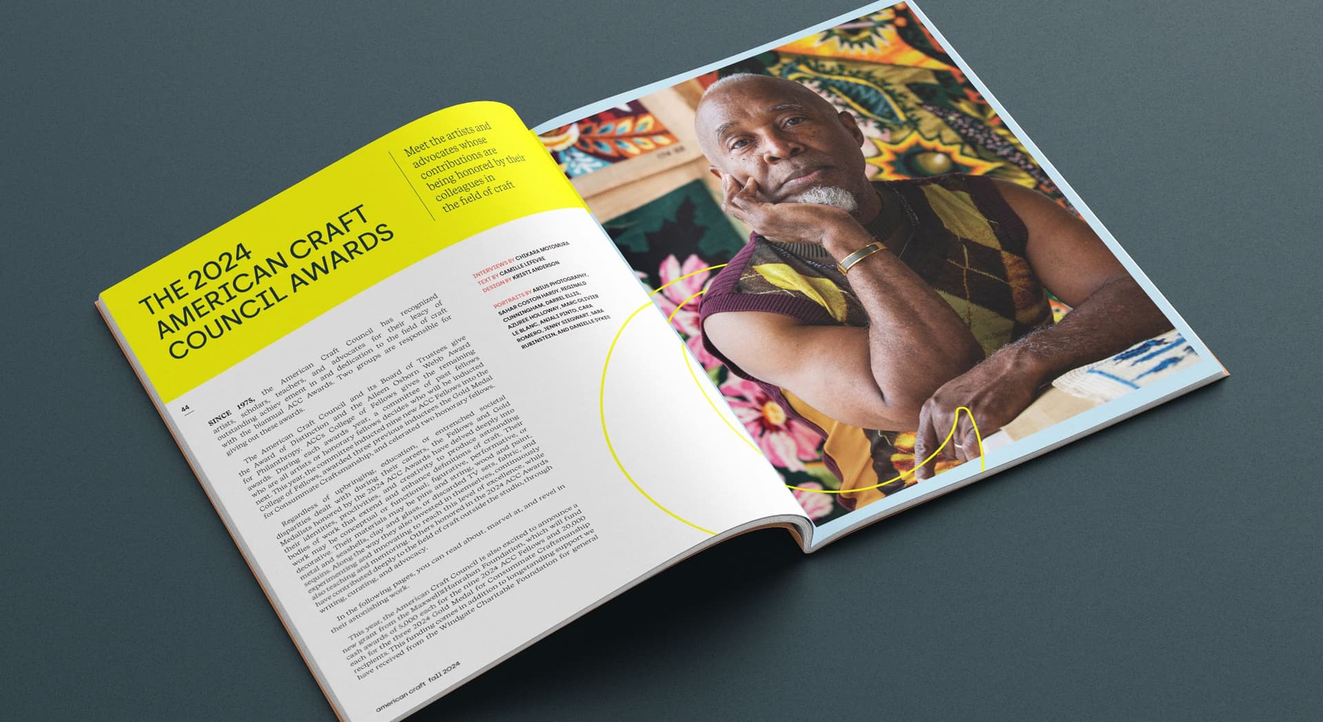 Magazine spread titled "The 2024 American Craft Council Awards" with a large photo of a man resting his face on his hand, wearing a sleeveless argyle sweater vest, sitting in front of colorful, patterned artwork. The left page contains text about the awards and some credits.