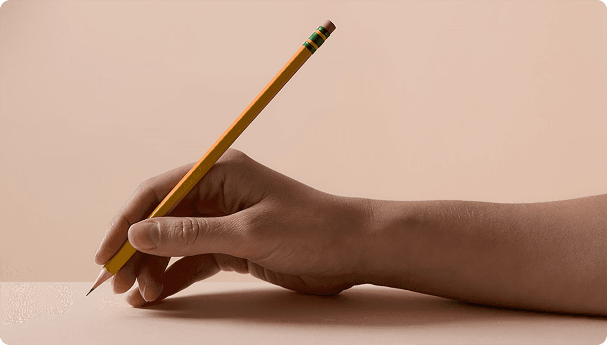 Hand holding a yellow pencil poised to write on a flat surface, against a neutral beige background.